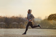 © baranq - Young man running at park during winter, autumn morning