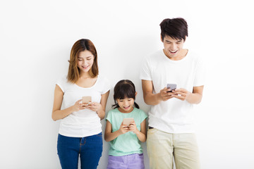 Family using smart phones while standing together