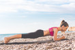 © _chupacabra_ - Dancer woman doing plank on the beach