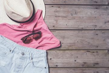 Wall Mural - Casual woman clothes on wooden table