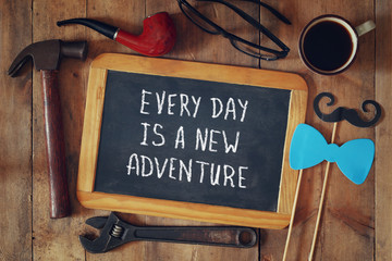 Wall Mural - chalkboard with the text everyday is a new adventure