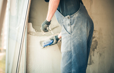 Wall Mural - man working with trowel on home walls