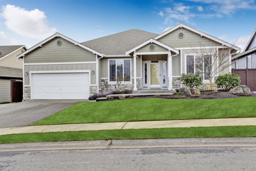 House exterior. View of entrance porch with walkway and garage