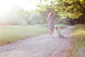 Wall Mural - girl walking with labrador retriever dog in park