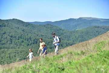 family of four hiking in the mountain