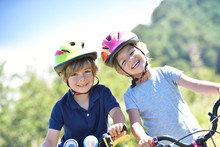Portrait Of Cheerful Kids Riding Bikes