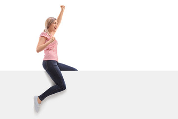 Wall Mural - Overjoyed woman sitting on a panel