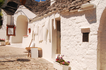 Wall Mural - A characteristic square of Alberobello with its famous Trulli -