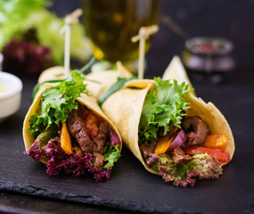 Wall Mural - Mexican fajitas for beef and grilled vegetables (paprika, red onion, tomato).