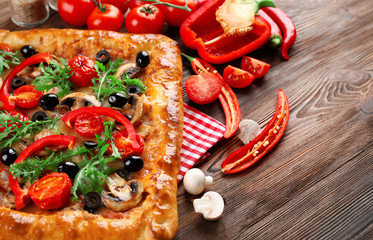 Canvas Print - Freshly homemade pizza on wooden background