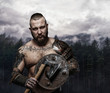 Viking holding wooden shield and axe.