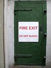Fire Exit Do Not Block! Sign On A Green Door
