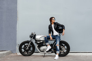 Biker woman in leather jacket on motorcycle