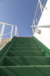 Stairway to heaven, green metal stairs on a ferry boat, against beautiful bright blue summer sky