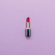 Flat lay fashion set: red lipstick on pastel background.