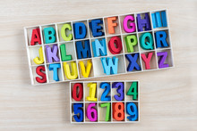 Colorful Alphabet Letters And Number In A Wooden Box With Square Compartments For Teaching Kids To Read And Spell Overhead Viewful