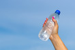 © gawriloff - Woman hand holding water bottle outdoors