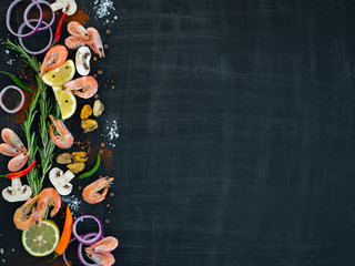  Seafood with vegetables and herbs on a wooden background . View from above. Space for text .