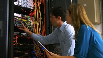 Fototapete - Technician looking at open server locker