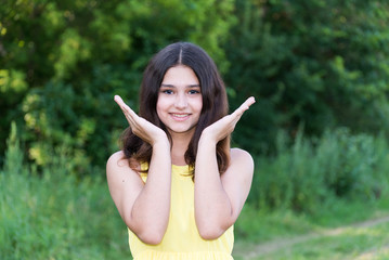 Wall Mural - Young beautiful girl playing in nature