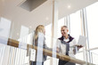 © Astrakan Images - Low angle view of happy business people shaking hands at hotel lobby