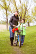 © viktoriia1974 - Daughter and mother walk along the shore of the lake with a bike and talk. Family values, education