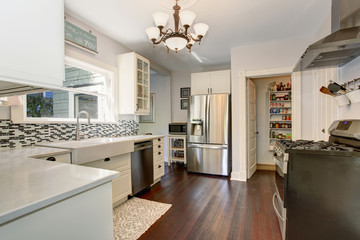 Wall Mural - White kitchen room with stainless steel fridge and hardwood floor.