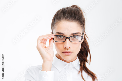 Fényképezés Closeup of serious beautiful young businesswoman in glasses