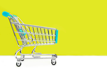 Cart from the grocery store on a red background. Retail trade and advertising. Purchase in the store.