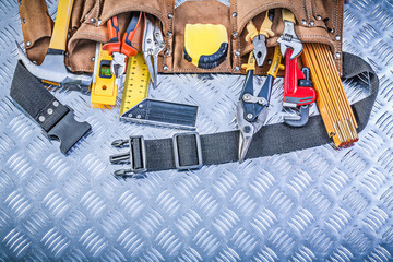 Assortment of construction tooling in leather building belt on c