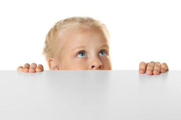 Poster - Funny little girl hiding behind white table