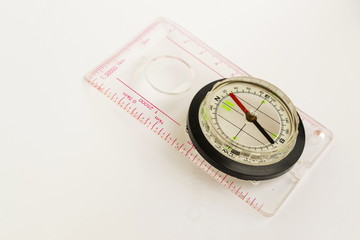 Detail shot of a glass compass on white background