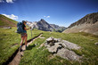 © goodmanphoto - a young woman hiking with a backpack in the mountains
