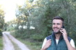 © ajr_images - Fellow tourist calling by phone phone in the forest