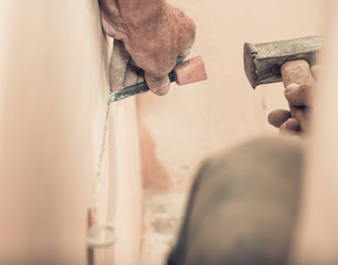 Wall Mural - worker making grooves for wire in wall