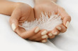 Closeup Of Beautiful Woman Hands Holding White Feather