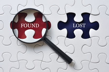 Magnifying Glass On Missing Puzzle With "FOUND/LOST" Word, Antonym Concept And Selective Focus