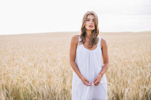 Portrait Of A Woman Standing In Wheat Field