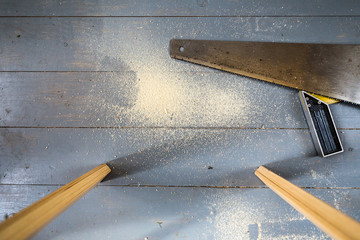 hand saw and sawdust on the floor during the repair