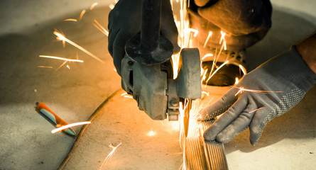 Wall Mural - worker cutting metallic profile on floor