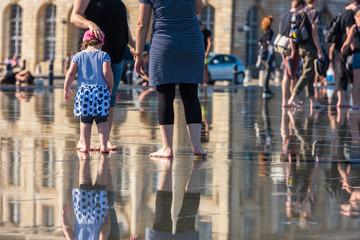 Poster - People having fun in a mirror fountain in Bordeaux, France