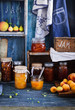 Canning fruts jam and jelly jars over wooden shelf with varities fruits. 