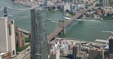 A Unique High-angle View Of The Brooklyn And Manhattan Bridges Over The East River In New York City.  	
