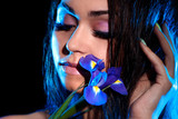 Fototapeta Łazienka - Woman with a blue flower of iris