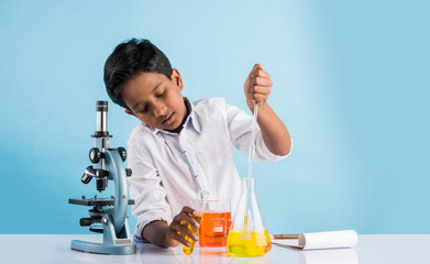 indian boy and chemistry experiment and microscope, asian boy with microscope and doing chemistry experiment, indian boy and science experiment