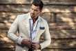 © Unique Vision - Portrait of young beautiful fashionable man against wooden wall.