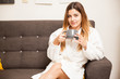 © AntonioDiaz - Cute woman in a robe drinking tea and relaxing