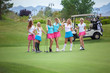 © BestStockFoto - Group of young female golf caddies on golf course.