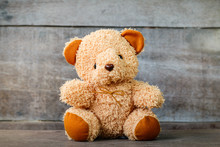 Cute Teddy Bears Sitting On Old Wood Background 