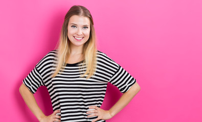 Wall Mural - Happy young woman with pink background